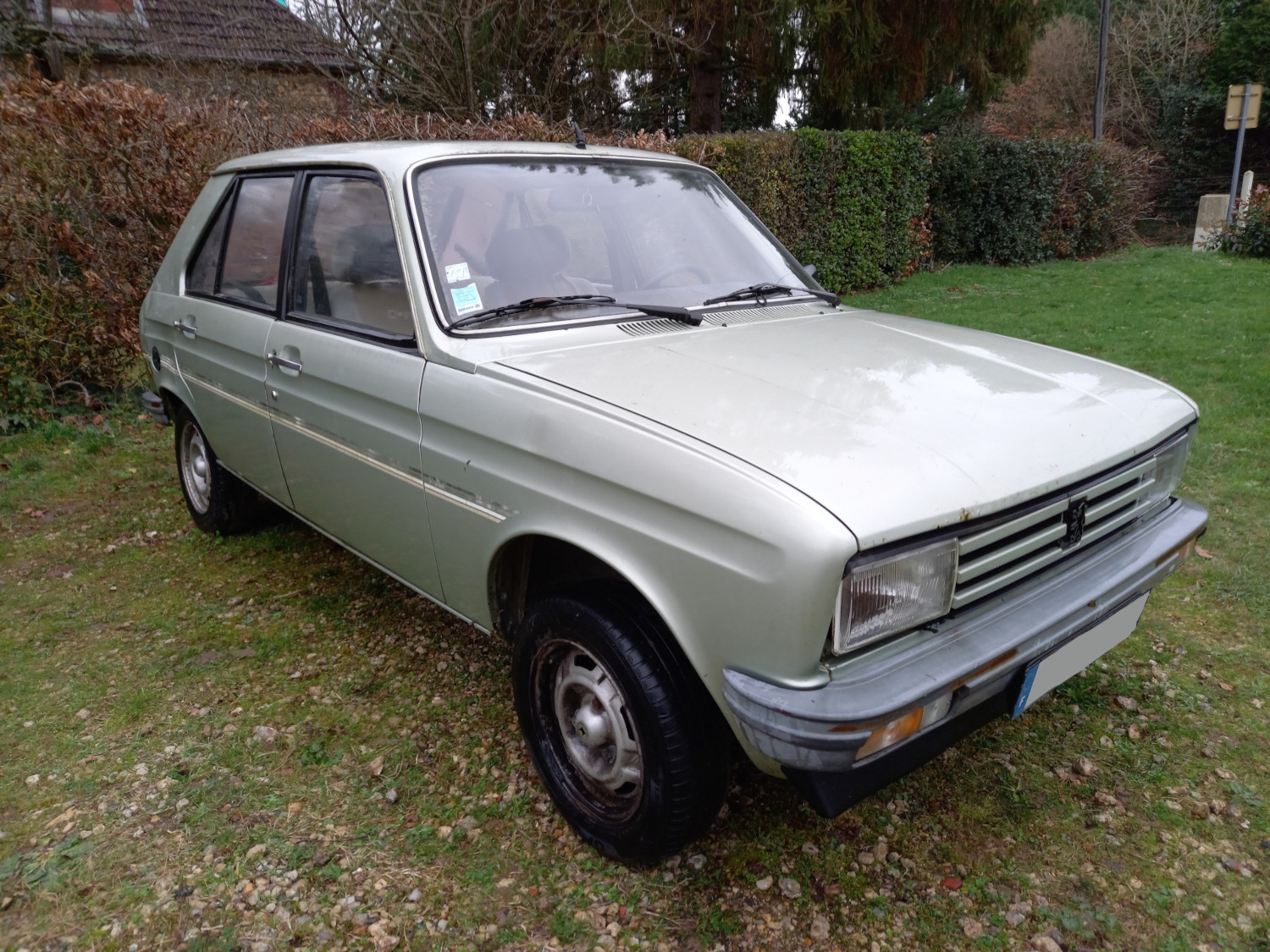 Zielony Peugeot 104 stojący na zewnątrz, widok 3/4 od strony pasażera